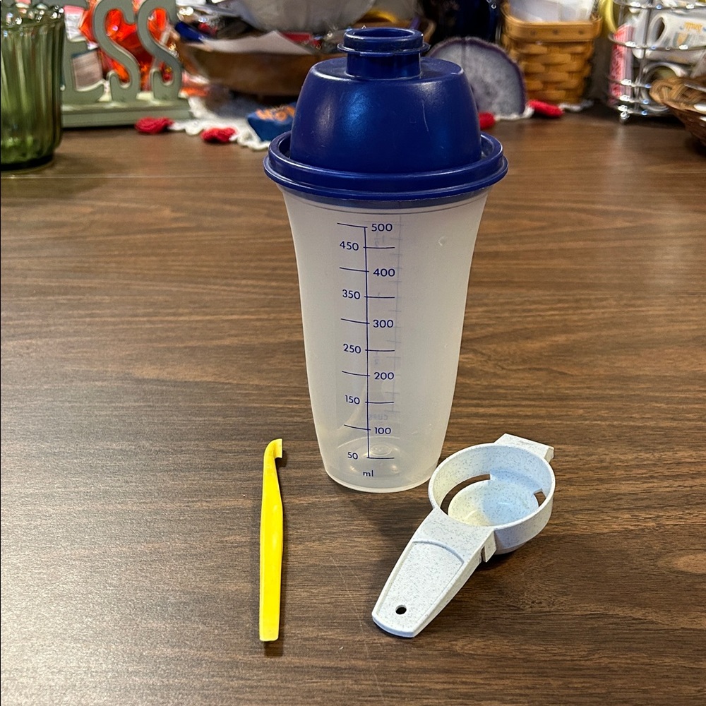 Tupperware Blue Shaker Bottle with Yellow Citrus Tool and Egg Separator.